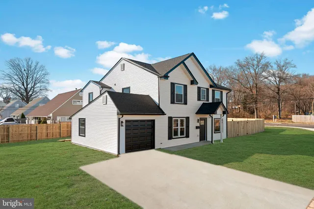 a front view of a house with a garden and yard
