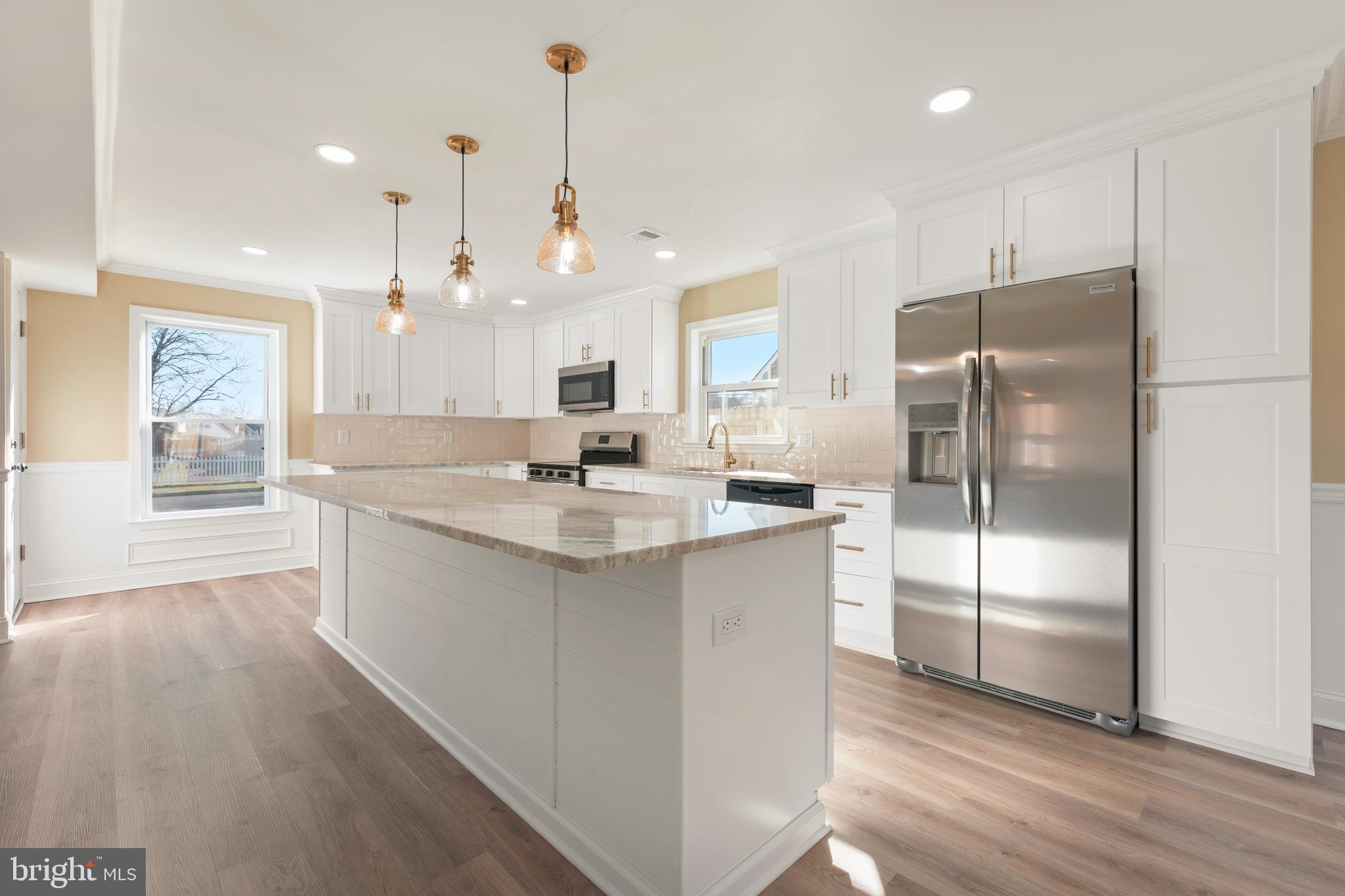 43 Petunia Road Levittown, PA 19056 - Photo 9 of 35 a kitchen with kitchen island a counter top space cabinets and stainless steel appliances