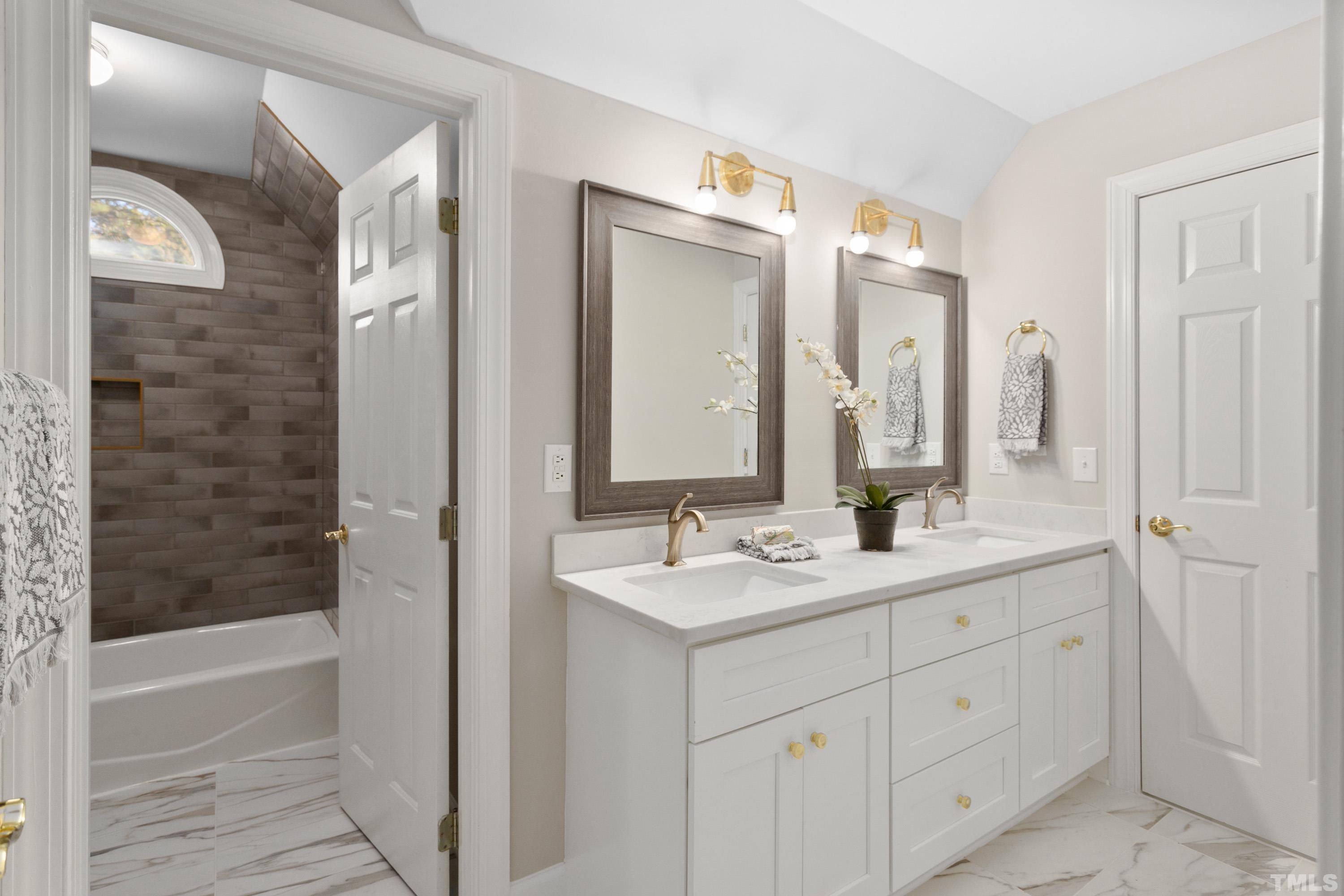 114 Old Pros Way Cary, NC 27513 - Photo 23 of 26 a bathroom with a double vanity sink and a mirror