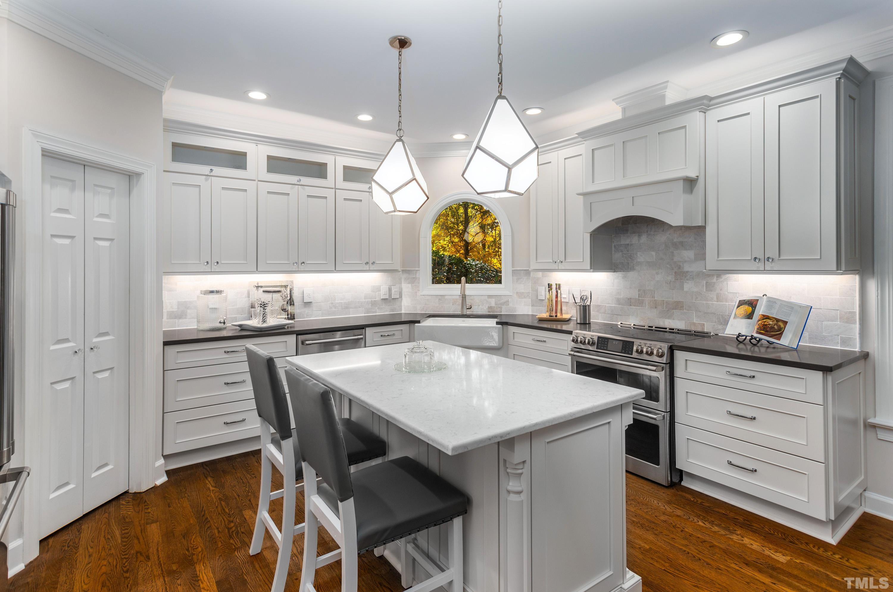114 Old Pros Way Cary, NC 27513 - Photo 5 of 26 a kitchen with a table chairs stove and cabinets