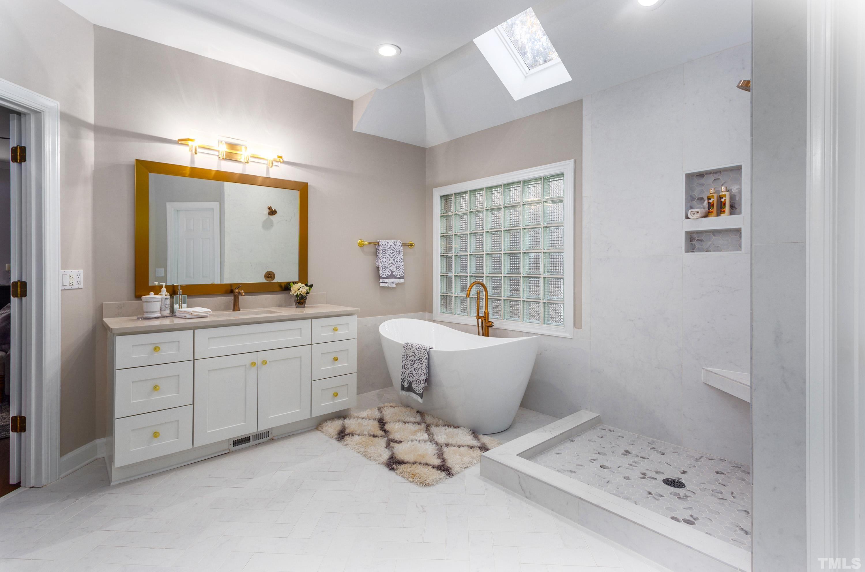 114 Old Pros Way Cary, NC 27513 - Photo 7 of 26 a bathroom with a bathtub sink and mirror