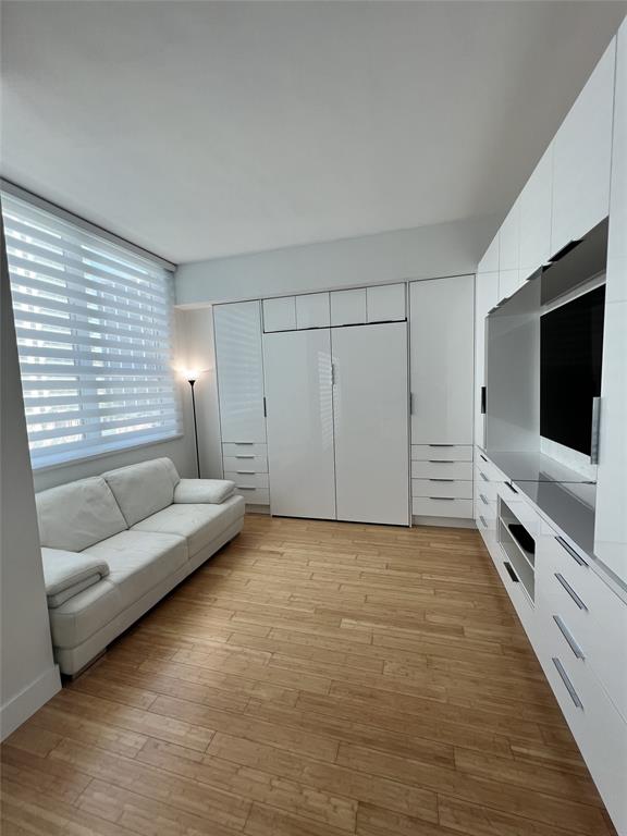 133 Northeast 2nd Avenue, Unit 1610 Miami, FL 33132 - Photo 12 of 52 a living room with furniture and a flat screen tv