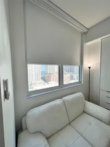 a view of a room with wooden floor and windows