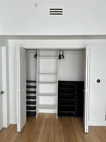 a view of walk in closet with empty racks