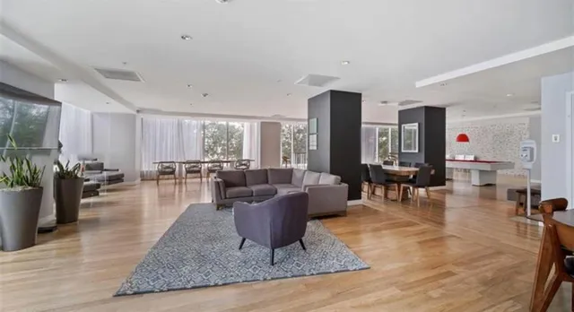 a dining room with furniture and a potted plant