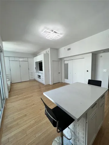 a view of an empty room with glass door