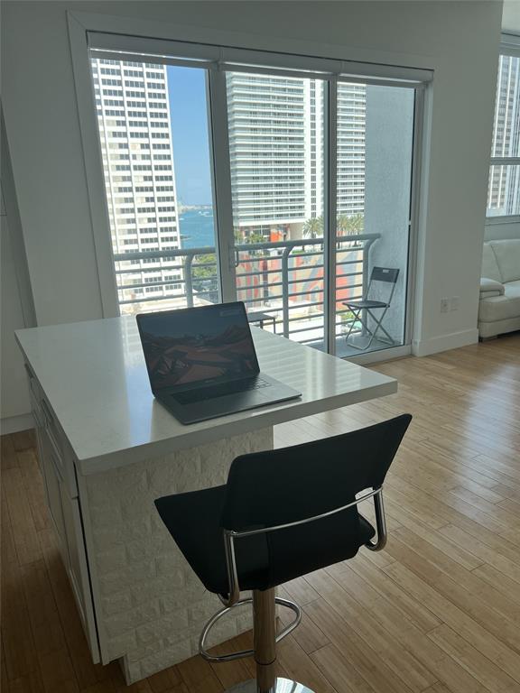 133 Northeast 2nd Avenue, Unit 1610 Miami, FL 33132 - Photo 7 of 52 a room with wooden floor and windows