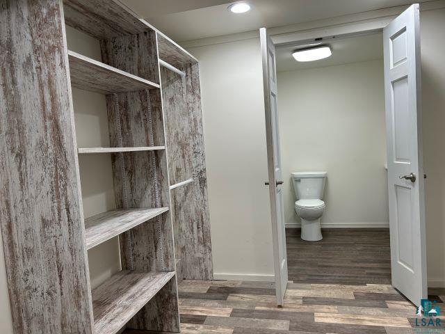 8353 Mannik Road Iron River, WI 54847 - Photo 21 of 52 Bathroom with dark wood finished floors, a closet, and recessed lighting