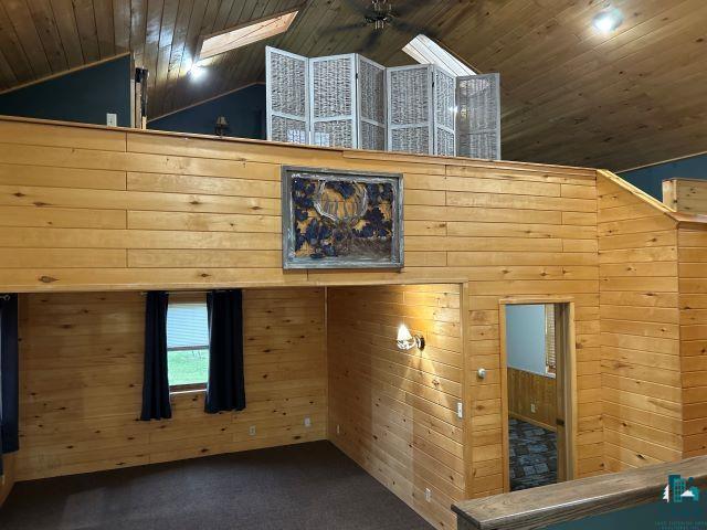 8353 Mannik Road Iron River, WI 54847 - Photo 35 of 52 Detailed view of carpet flooring, wood walls, and wooden ceiling