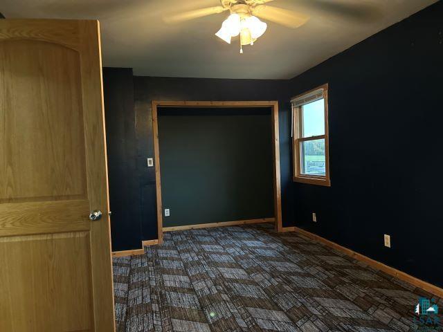 8353 Mannik Road Iron River, WI 54847 - Photo 49 of 52 Empty room with ceiling fan and dark colored carpet