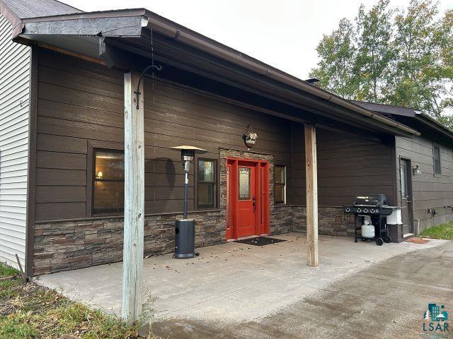 8353 Mannik Road Iron River, WI 54847 - Photo 52 of 52 Entrance to property featuring stone siding and covered porch