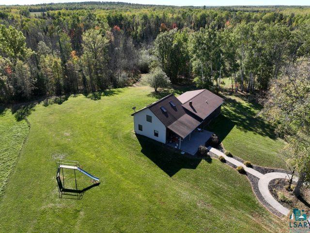 8353 Mannik Road Iron River, WI 54847 - Photo 6 of 52 Aerial view of property and surrounding area with a heavily wooded area