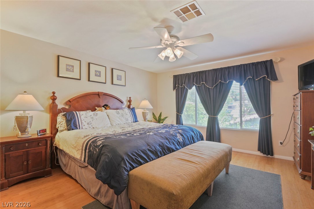 2356 Tilden Way Henderson, NV 89074 - Photo 16 of 30 Well-lit sleeping quarters with bright wood-look flooring and a window offering natural light.