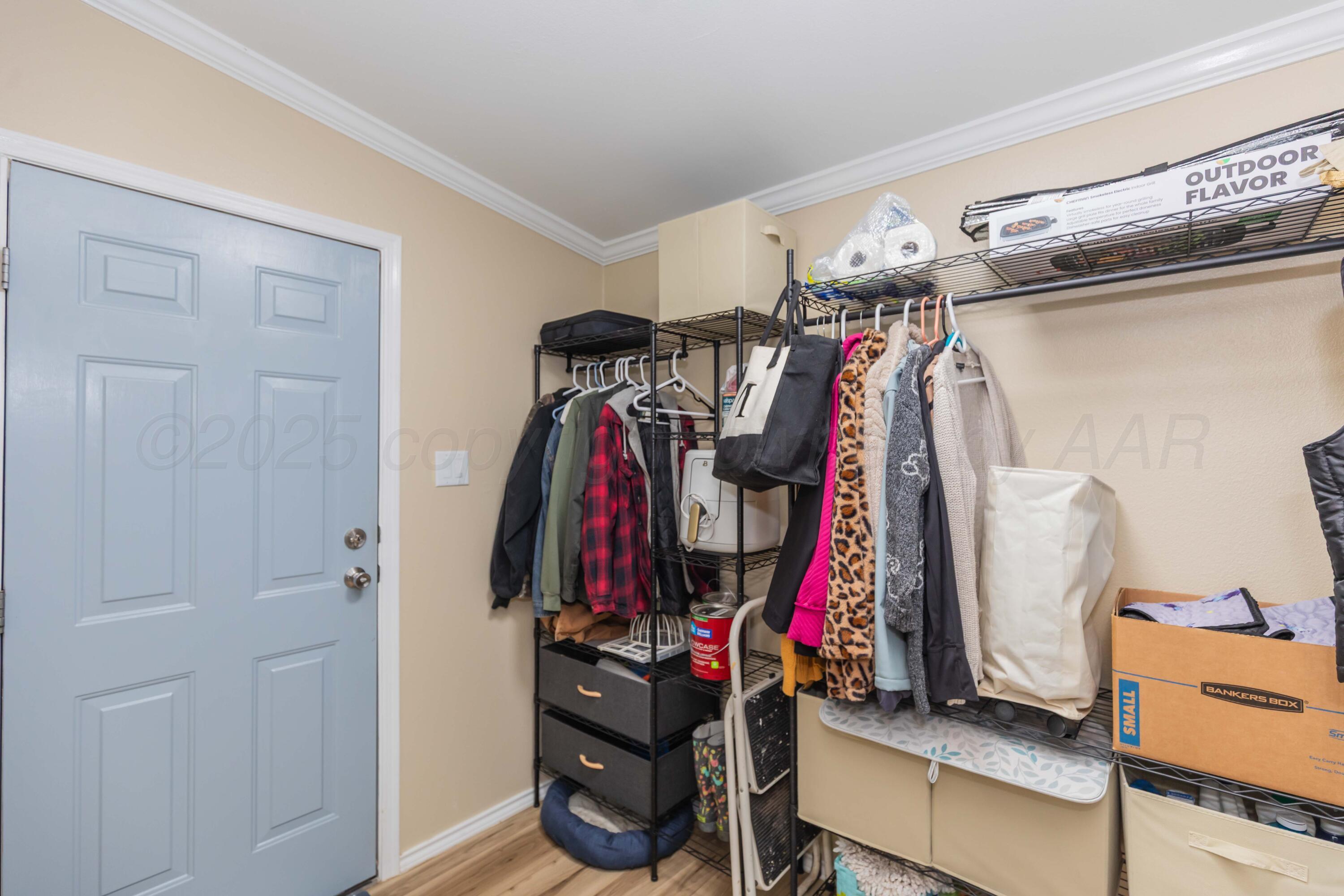 22701 South Blessen Road Canyon, TX 79015 - Photo 23 of 32 a view of walk in closet with clothes