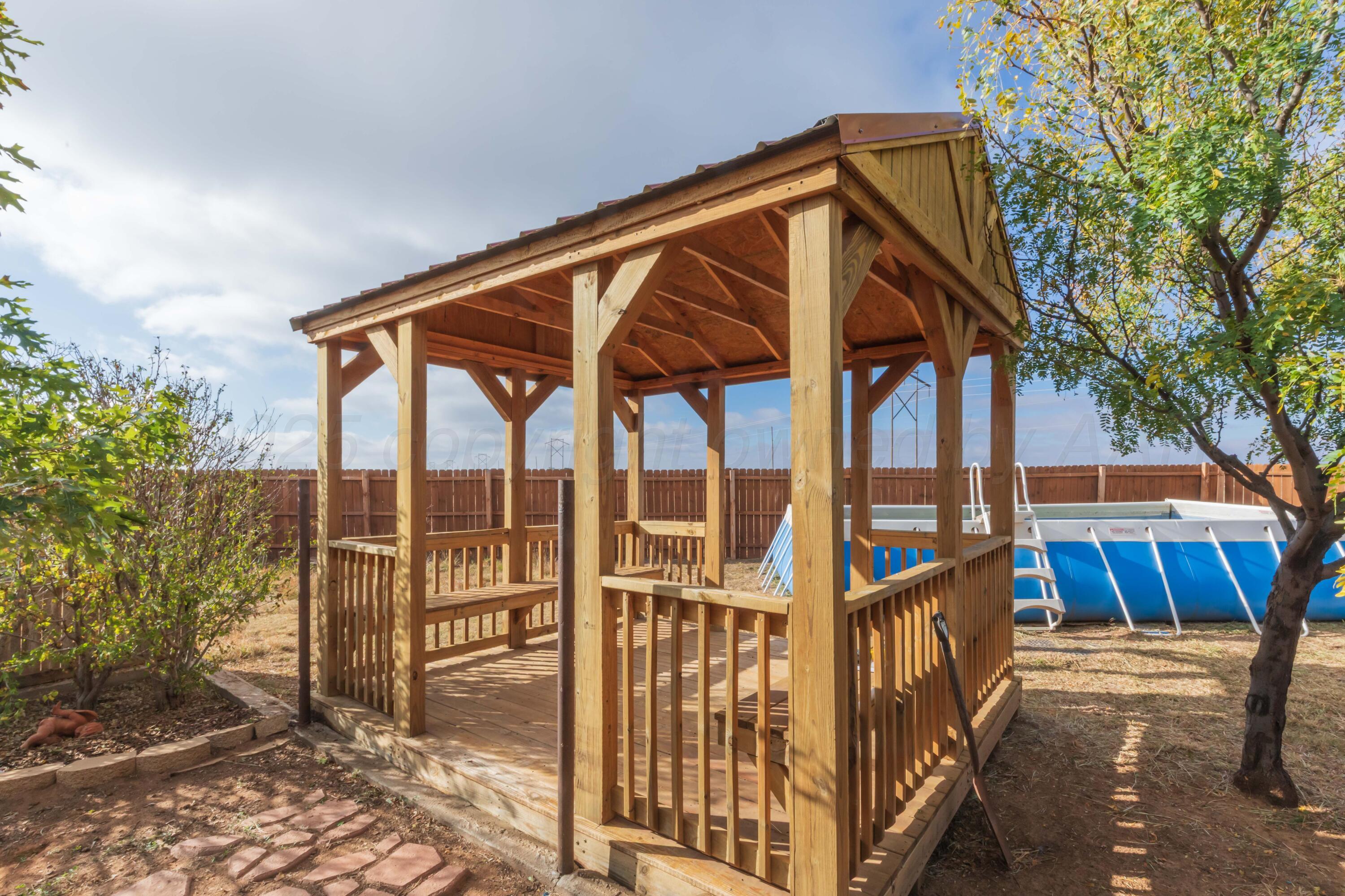 22701 South Blessen Road Canyon, TX 79015 - Photo 25 of 32 a view of wooden house with a small yard and wooden fence