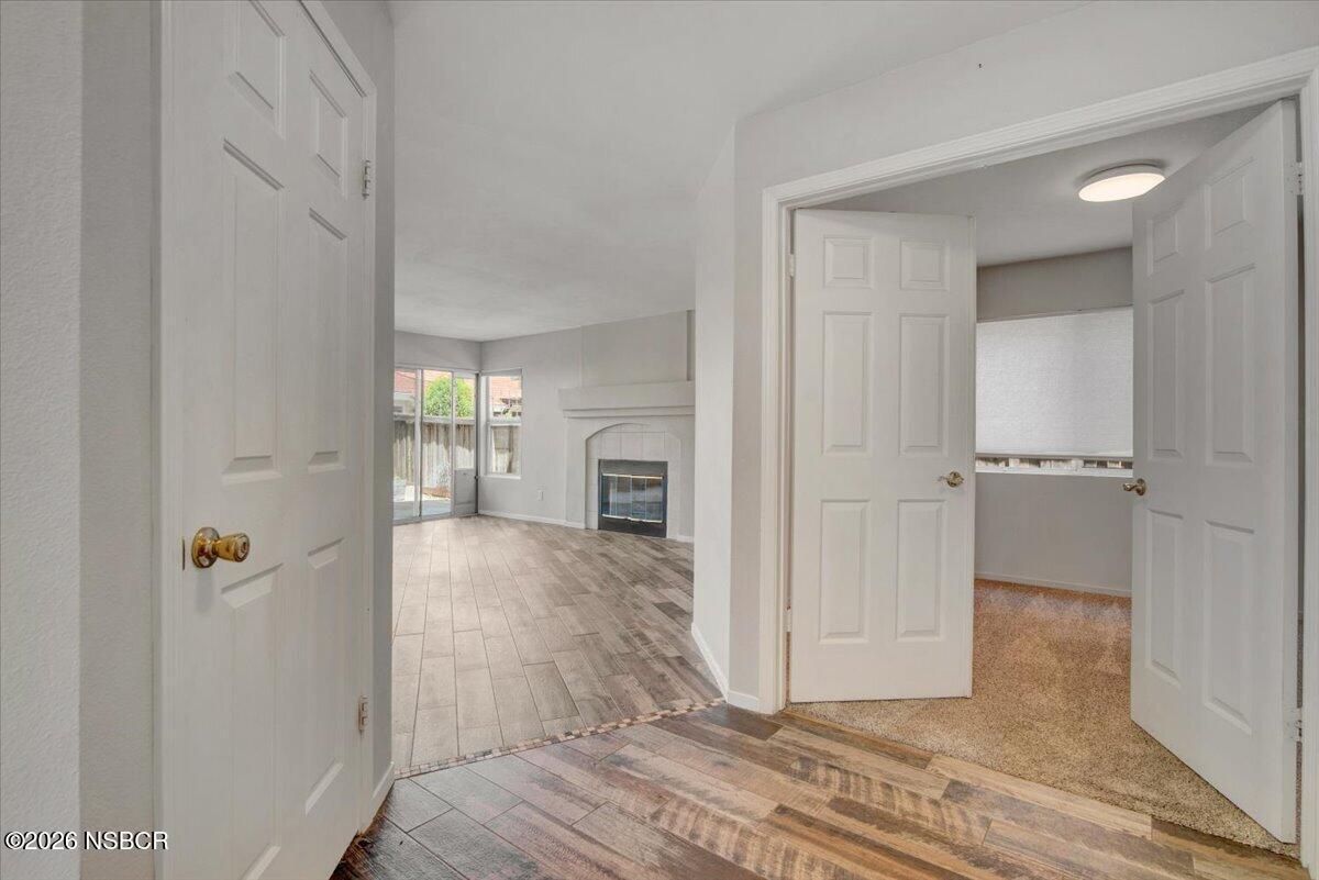 1248 Stonebrook Drive Lompoc, CA 93436 - Photo 14 of 38 a view of a hallway with wooden floor and a cabinet