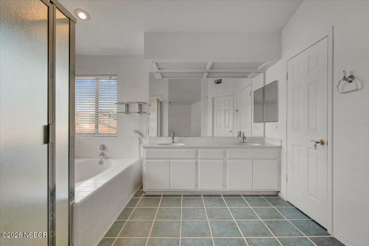1248 Stonebrook Drive Lompoc, CA 93436 - Photo 24 of 38 a spacious bathroom with a bathtub sink and mirror