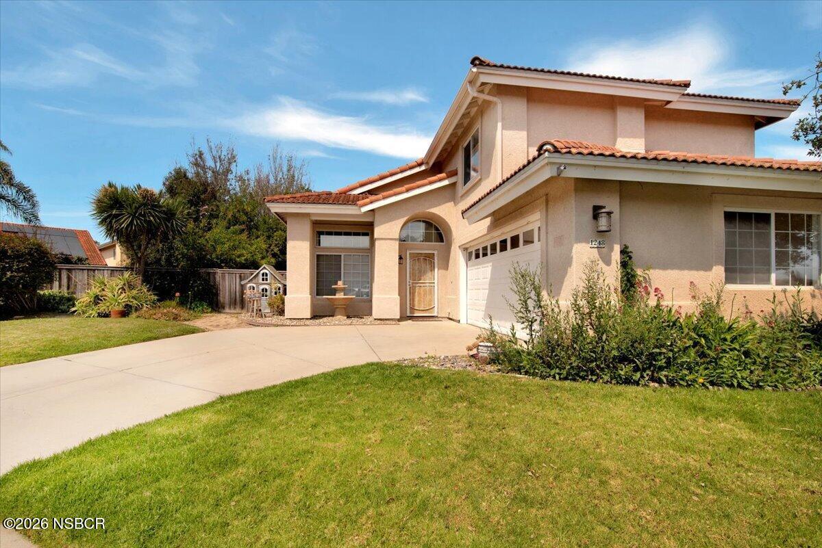 1248 Stonebrook Drive Lompoc, CA 93436 - Photo 3 of 38 a front view of a house with a yard