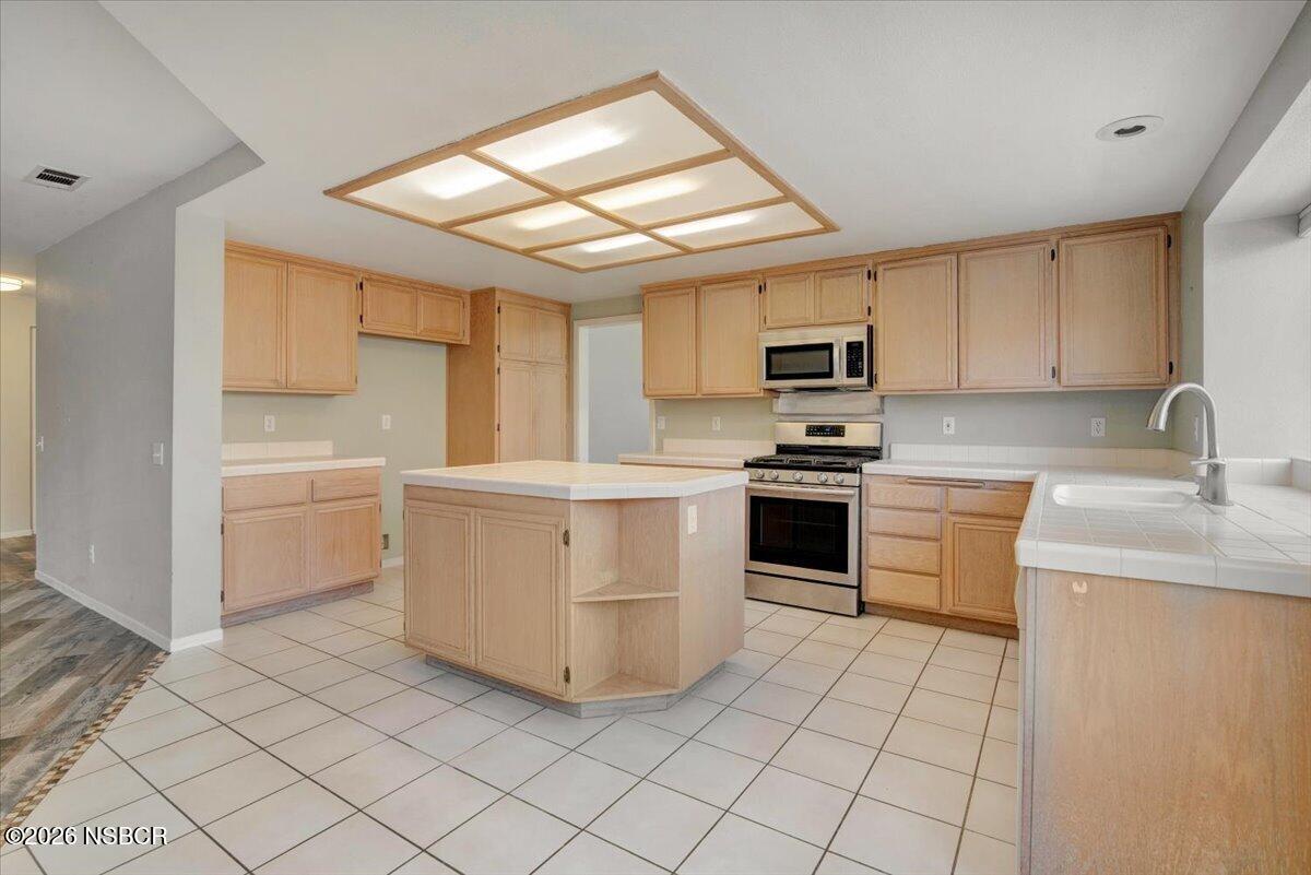 1248 Stonebrook Drive Lompoc, CA 93436 - Photo 9 of 38 a kitchen with a stove sink and a microwave