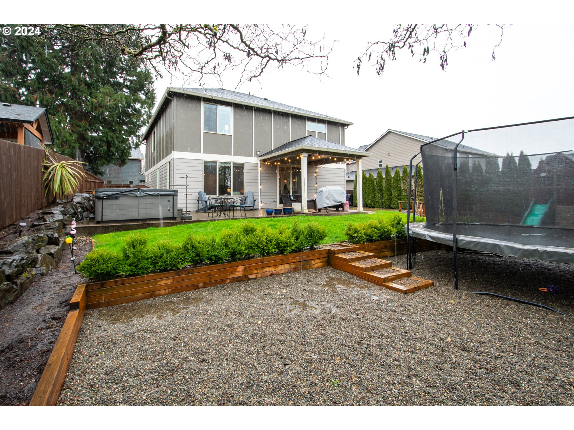 2804 Northeast 167th Circle Ridgefield, WA 98642 - Photo 32 of 36 a view of a house with a yard and a garden