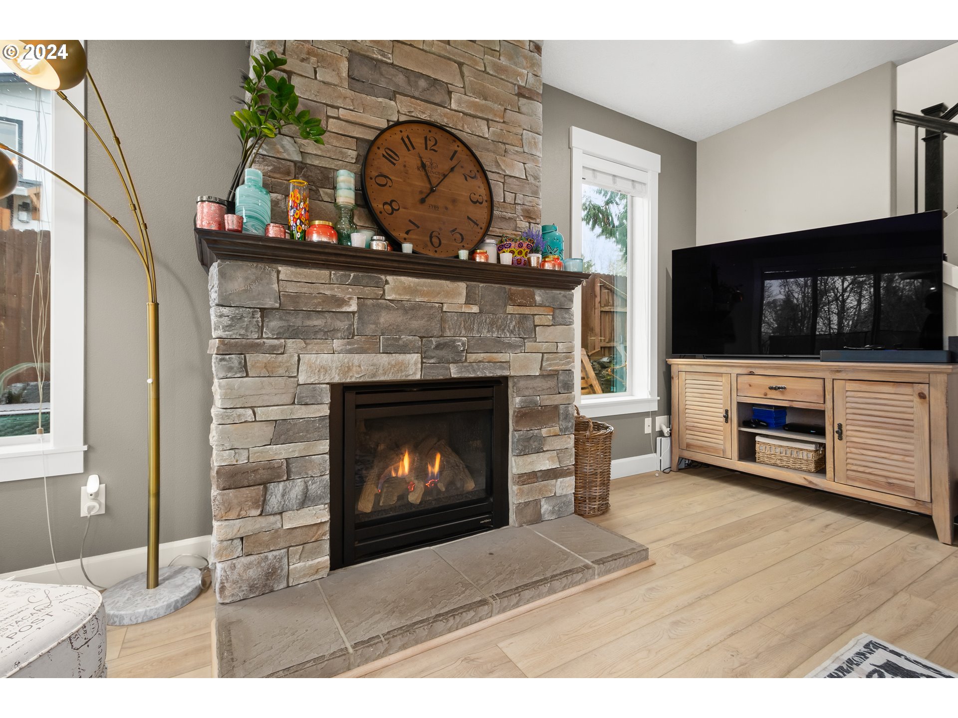 2804 Northeast 167th Circle Ridgefield, WA 98642 - Photo 8 of 36 a living room with a fireplace a flat screen tv and a fireplace