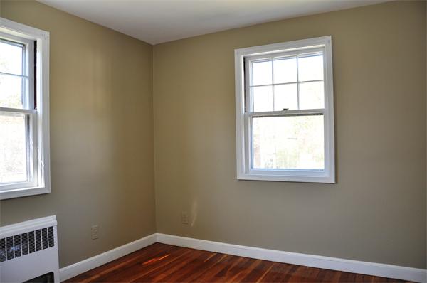36 Coolidge Road Milton, MA 02186 - Photo 11 of 12 an empty room with wooden floor and windows