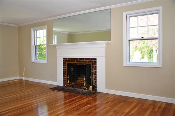 36 Coolidge Road Milton, MA 02186 - Photo 3 of 12 an empty room with windows and a fireplace