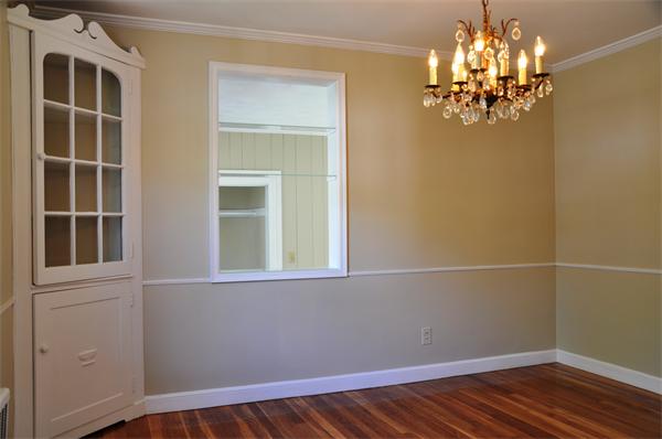 36 Coolidge Road Milton, MA 02186 - Photo 4 of 12 a view of a room with wooden floor and chandelier