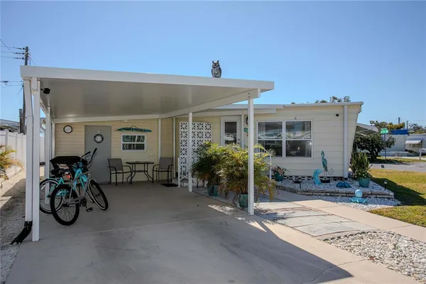 a view of a house with yard and sitting area