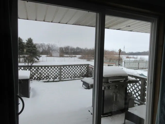 a view of backyard with swimming pool and outdoor seating