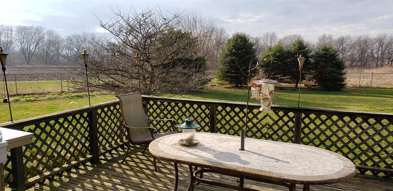 20172 Prophet Road Prophetstown, IL 61277 - Photo 32 of 32 a table and chairs with wooden floor in front of a house
