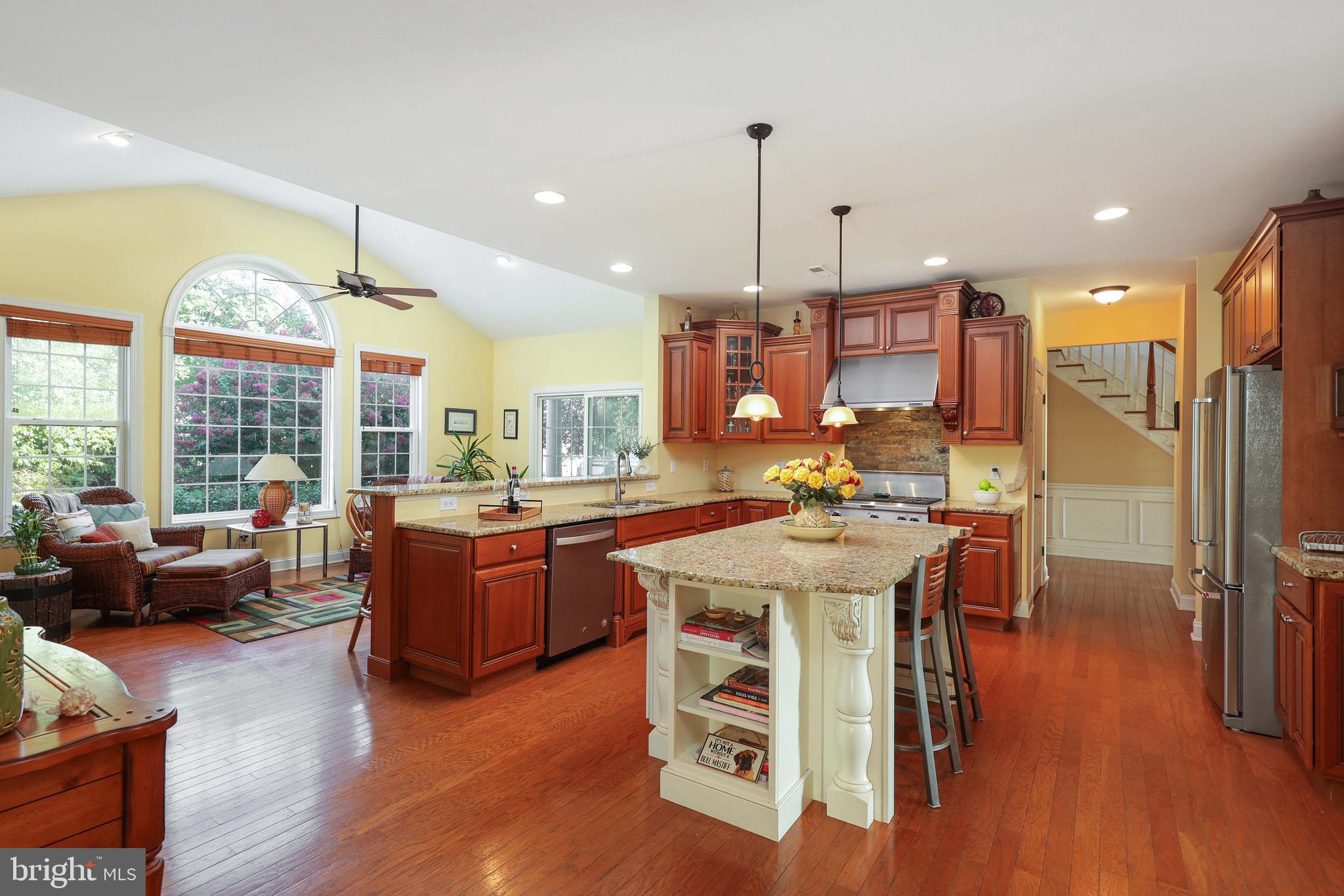 15 Manchester Court Columbus, NJ 08022 - Photo 14 of 80 a kitchen with stainless steel appliances granite countertop a stove a refrigerator a kitchen island dining table and a chandelier