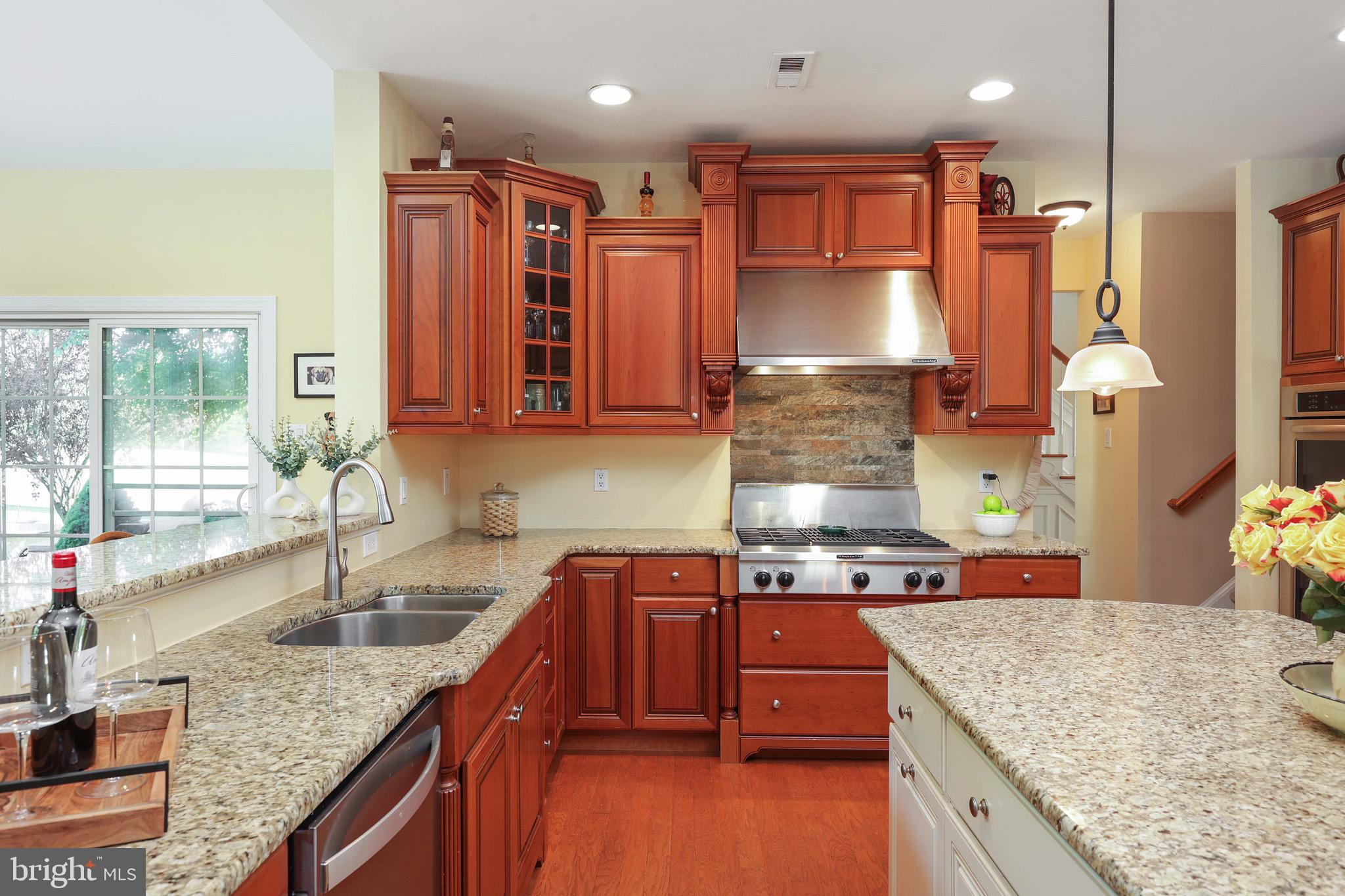 15 Manchester Court Columbus, NJ 08022 - Photo 16 of 80 a kitchen with stainless steel appliances granite countertop a sink a stove and a wooden cabinets