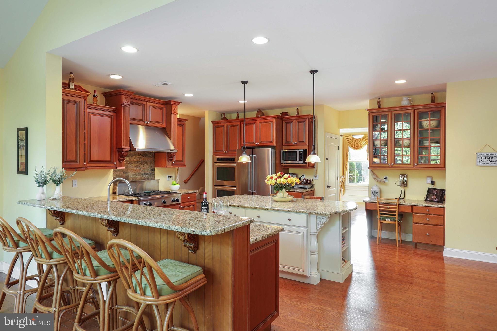 15 Manchester Court Columbus, NJ 08022 - Photo 18 of 80 a view of a kitchen with kitchen island granite countertop wooden floor stainless steel appliances and dining table