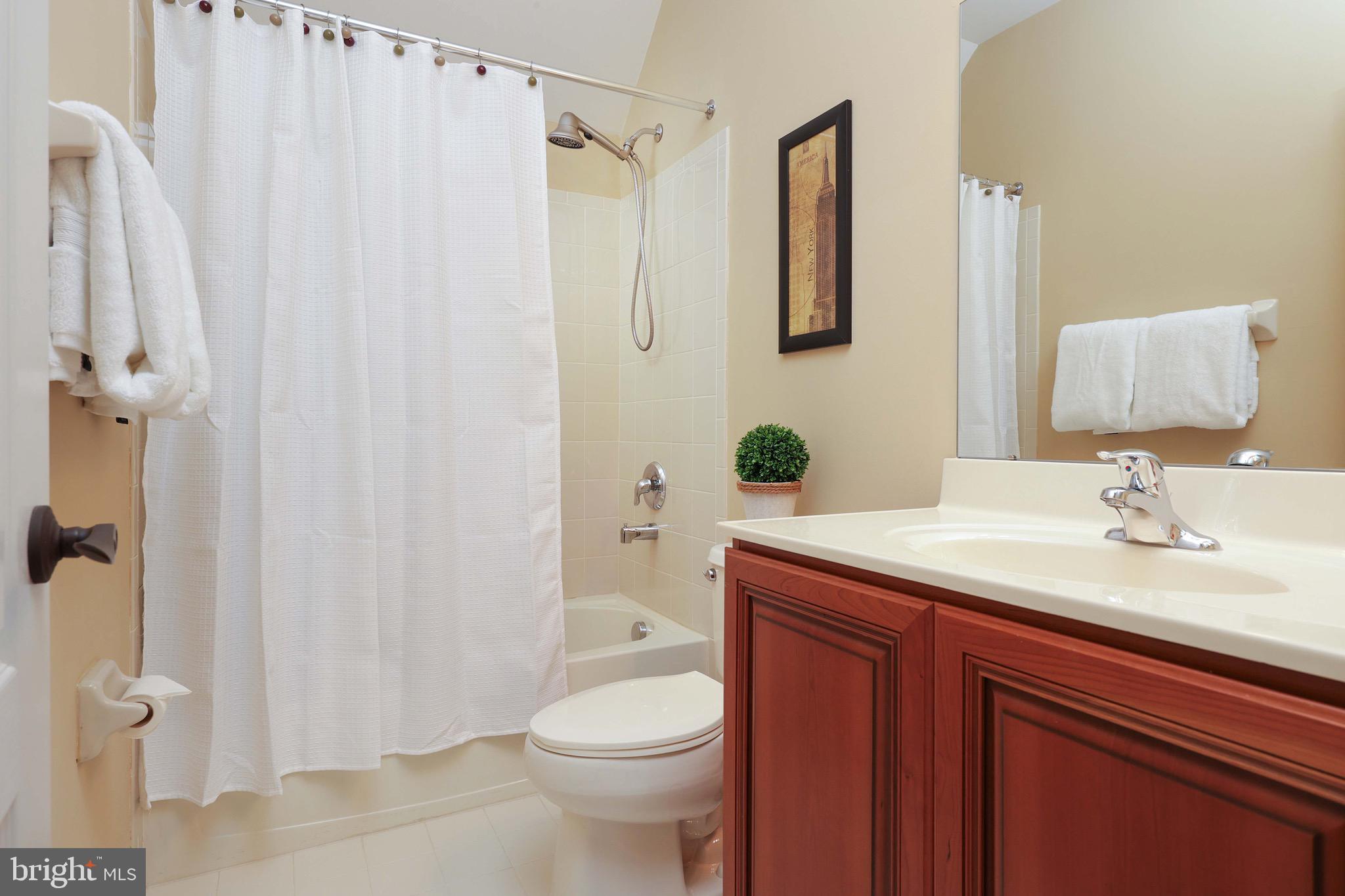 15 Manchester Court Columbus, NJ 08022 - Photo 29 of 80 a bathroom with a sink a toilet a mirror and shower