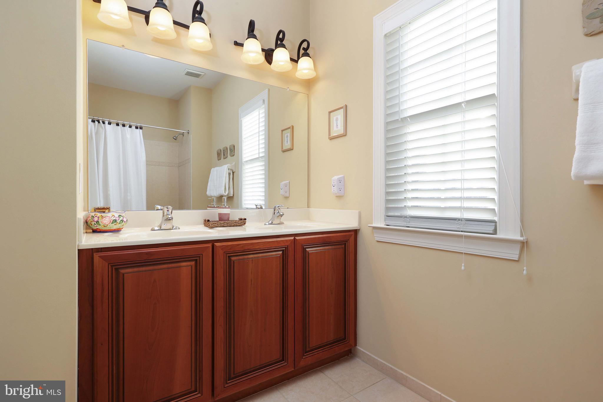 15 Manchester Court Columbus, NJ 08022 - Photo 32 of 80 a bathroom with a double vanity sink and a mirror