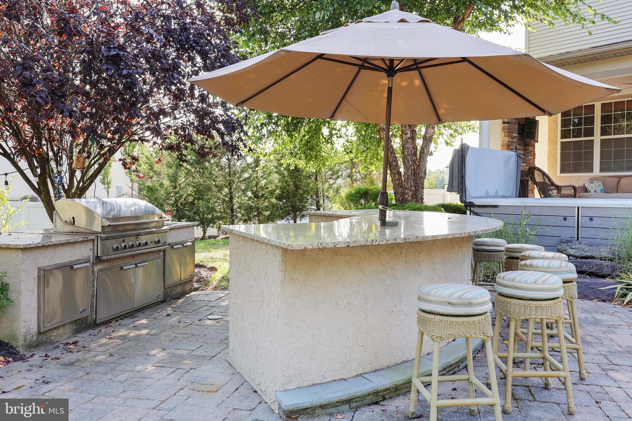 15 Manchester Court Columbus, NJ 08022 - Photo 39 of 80 a patio with a table and chairs under an umbrella