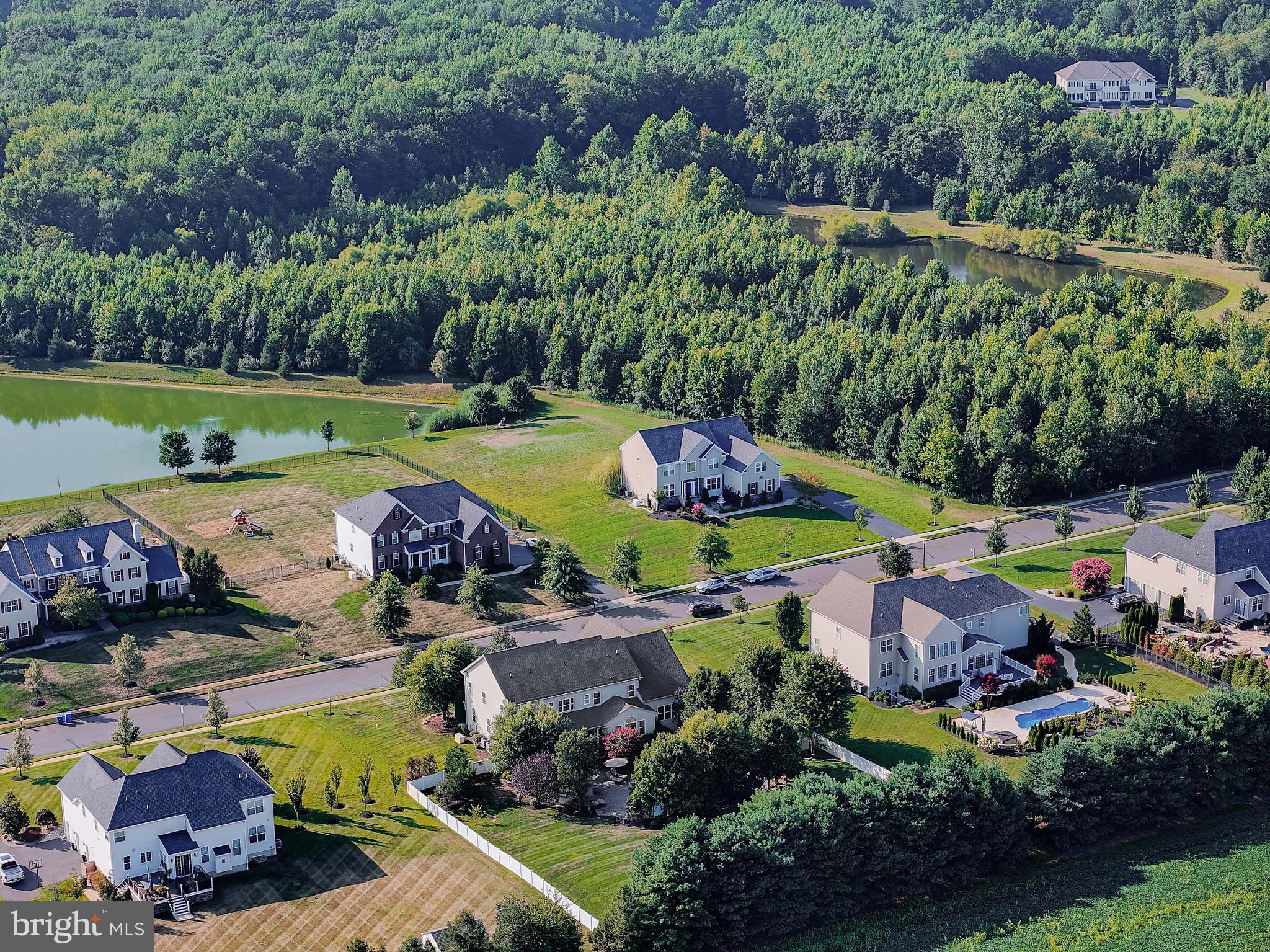 15 Manchester Court Columbus, NJ 08022 - Photo 73 of 80 a view of a swimming pool with lawn chairs and plants