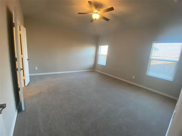 a view of a livingroom with a ceiling fan and window