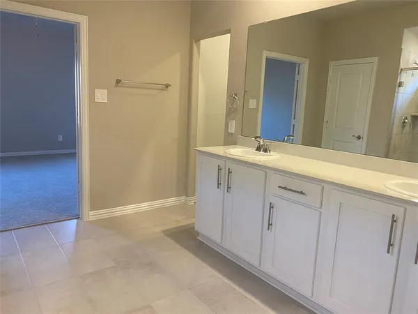 a spacious bathroom with a mirror