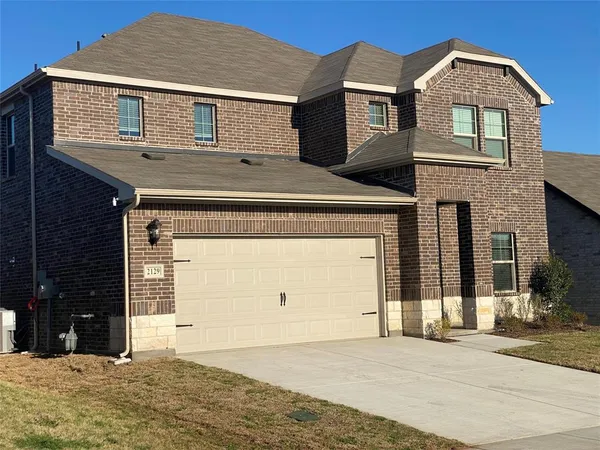 a front view of a house with a parking space