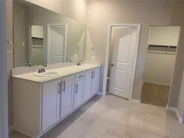 a bathroom with a double vanity sink and mirror