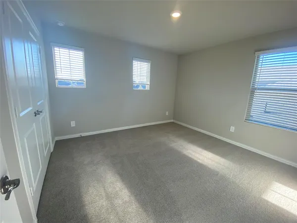 a view of a hallway with wooden floor and a living room