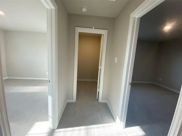 a view of a hallway with closet and wooden floor