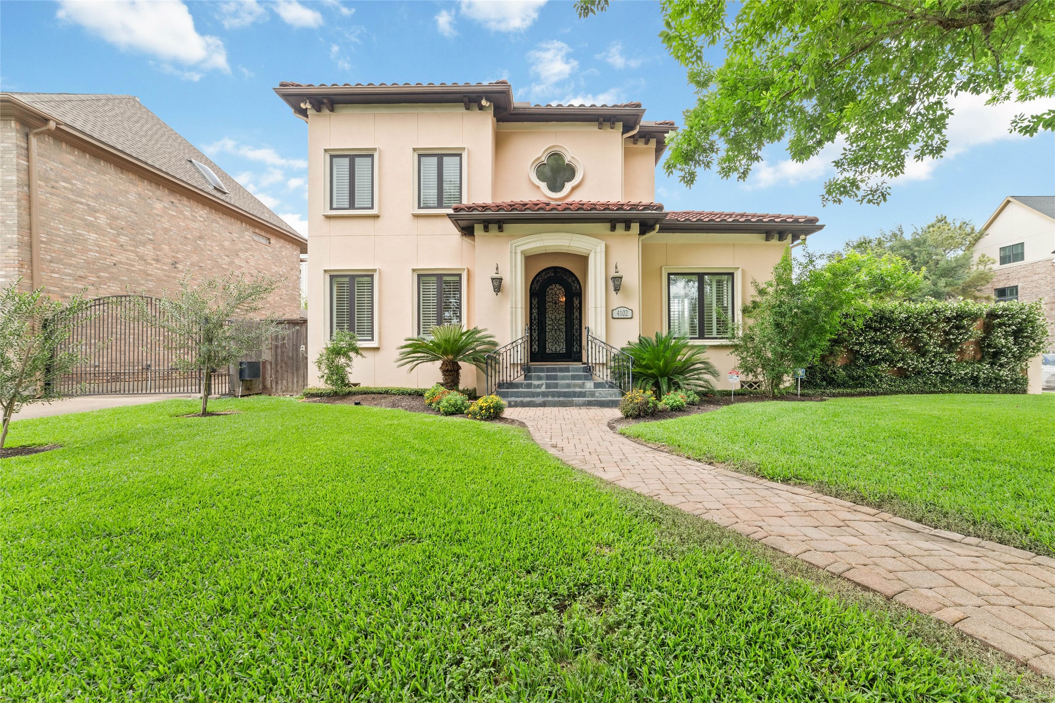 4102 Gramercy Street Houston, TX 77025 - Photo 1 of 35 a front view of a house with a garden and plants