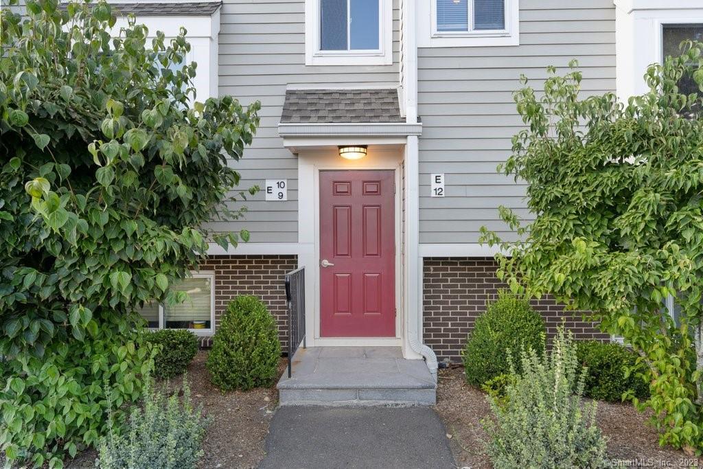 71 Aiken Street, Unit E12 Norwalk, CT 06851 - Photo 1 of 1 a front view of a house with a garage