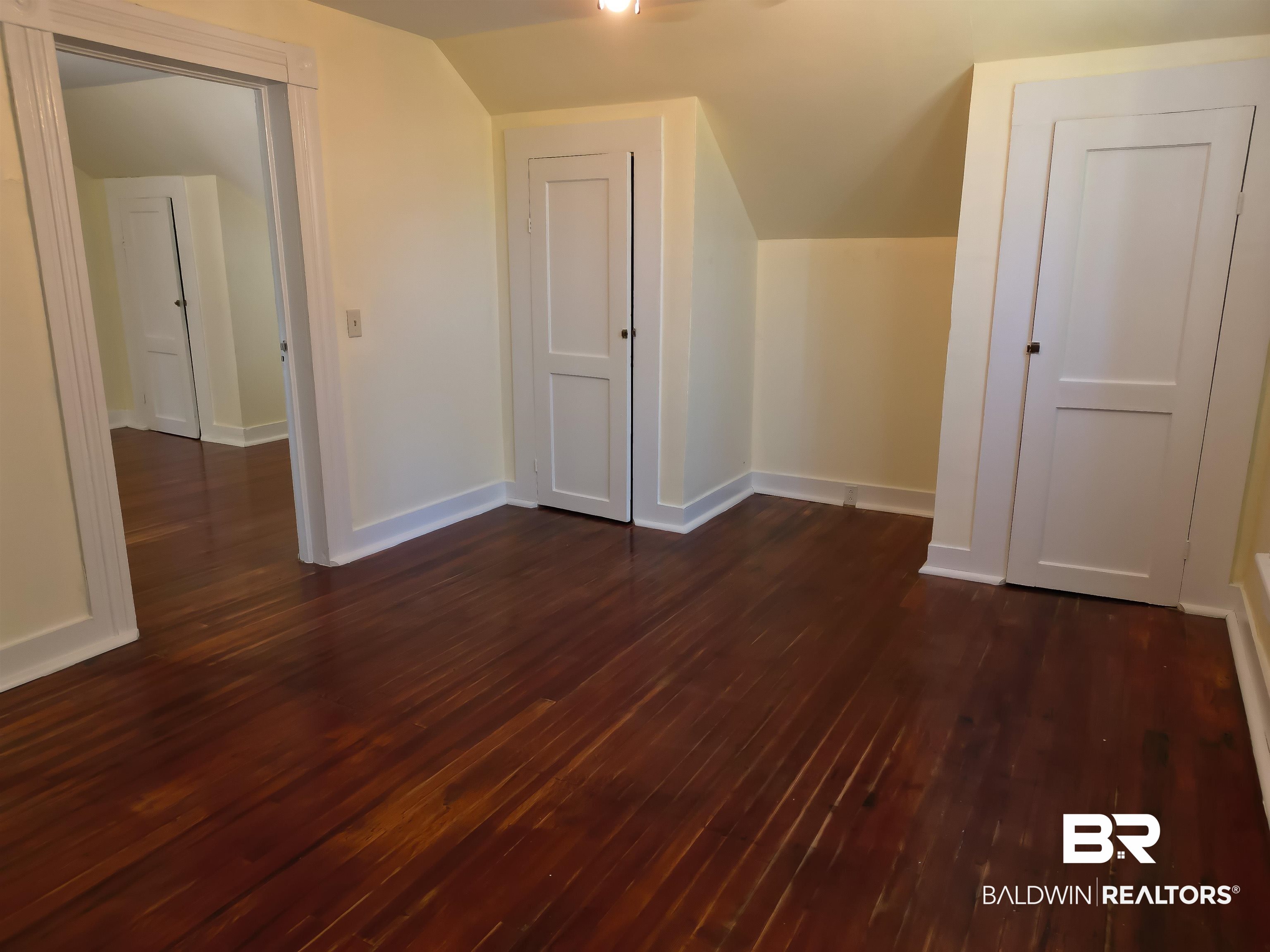 73 Liberty Street Monroeville, AL 36460 - Photo 26 of 29 Bonus room with vaulted ceiling and dark hardwood / wood-style floors