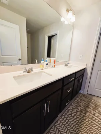 a kitchen with stainless steel appliances a refrigerator a stove a sink dishwasher and a dining table with wooden floor