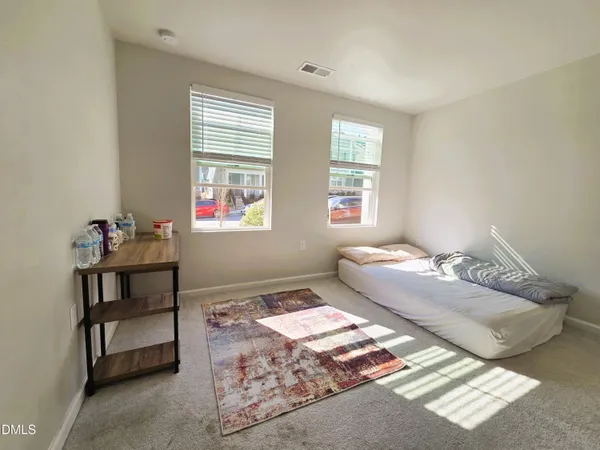 a view of a hallway with wooden floor and entryway