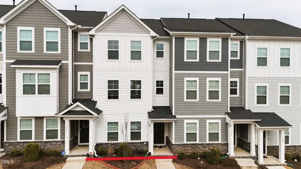 a front view of a residential apartment building with a yard